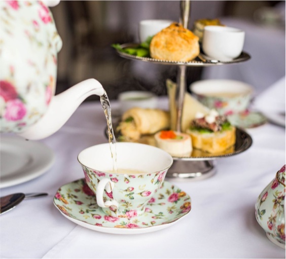 Tea pouring next to delicious food